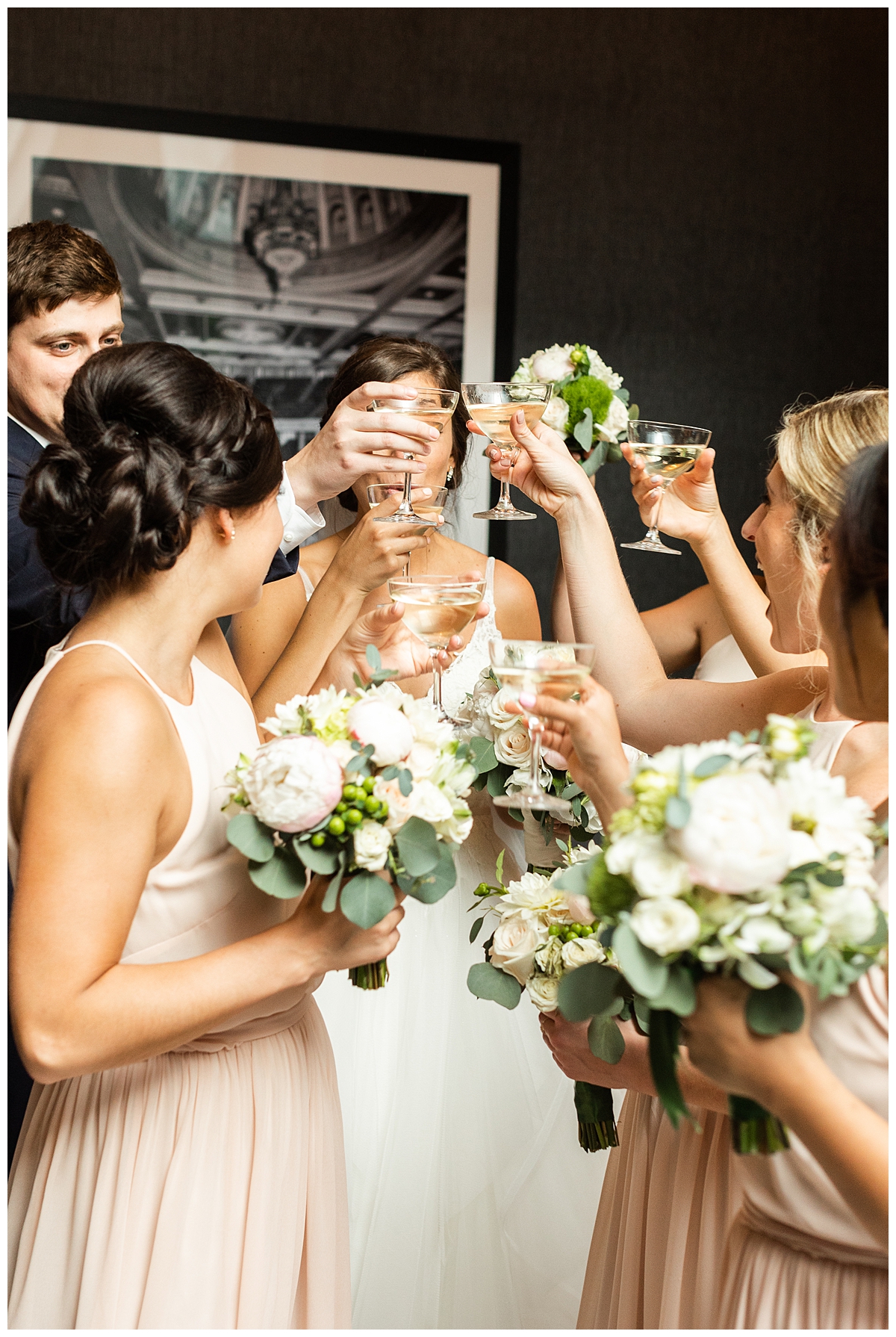 The bridal party toasts with drinks. 