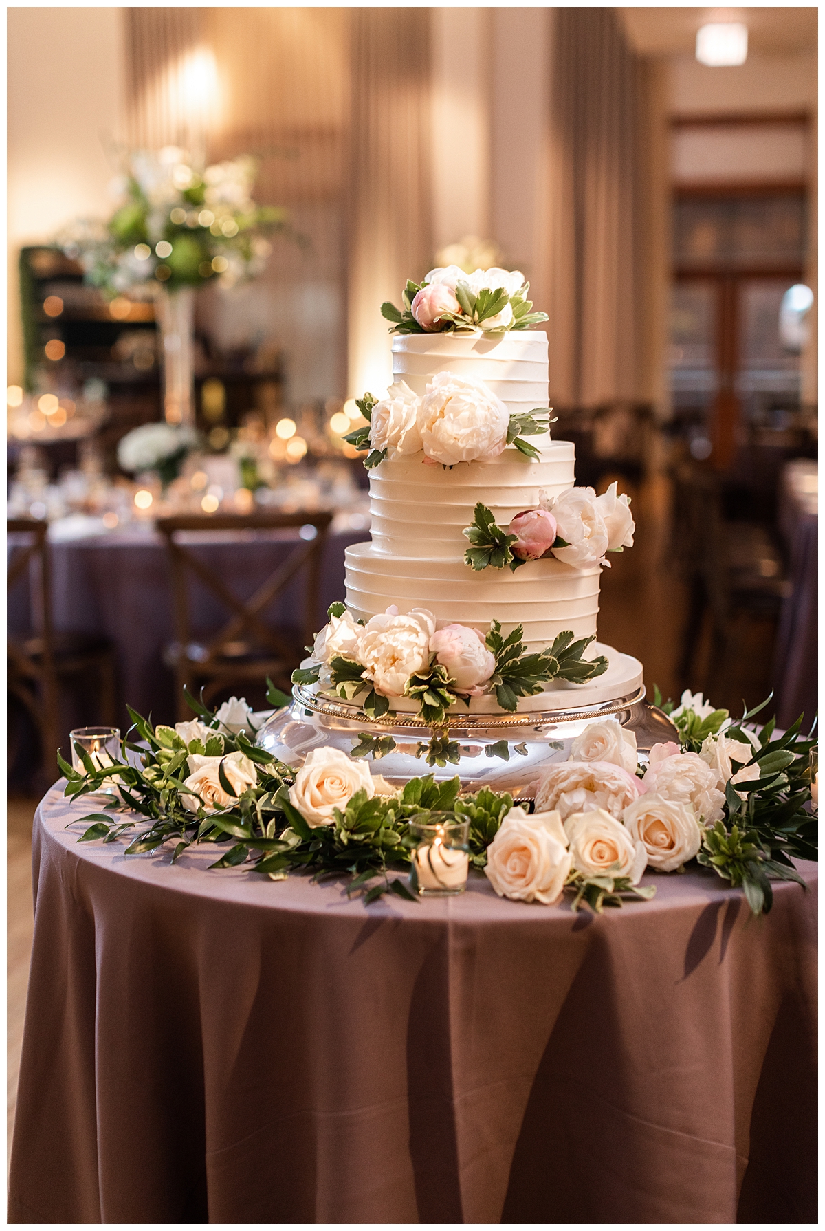 A white bride's cake is on display at a reception in the ballroom at the Ivy Room in Chicago. 