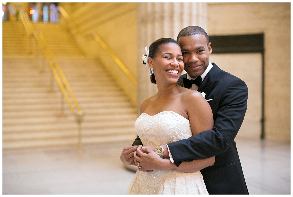 A bride and groom smile in a wedding portrait 