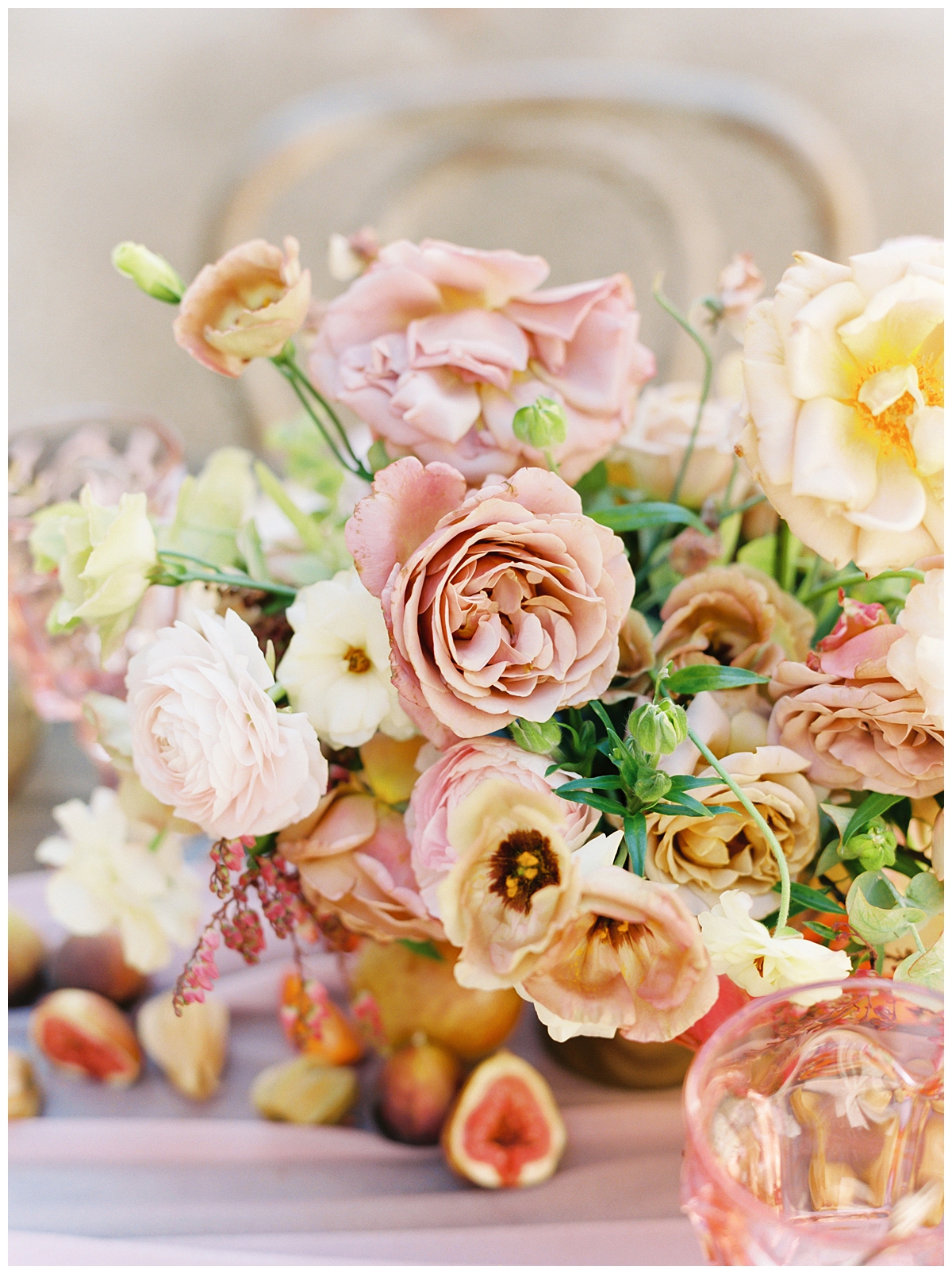 A wedding bouquet is displayed in varying shades of light pink, yellow, and green. 