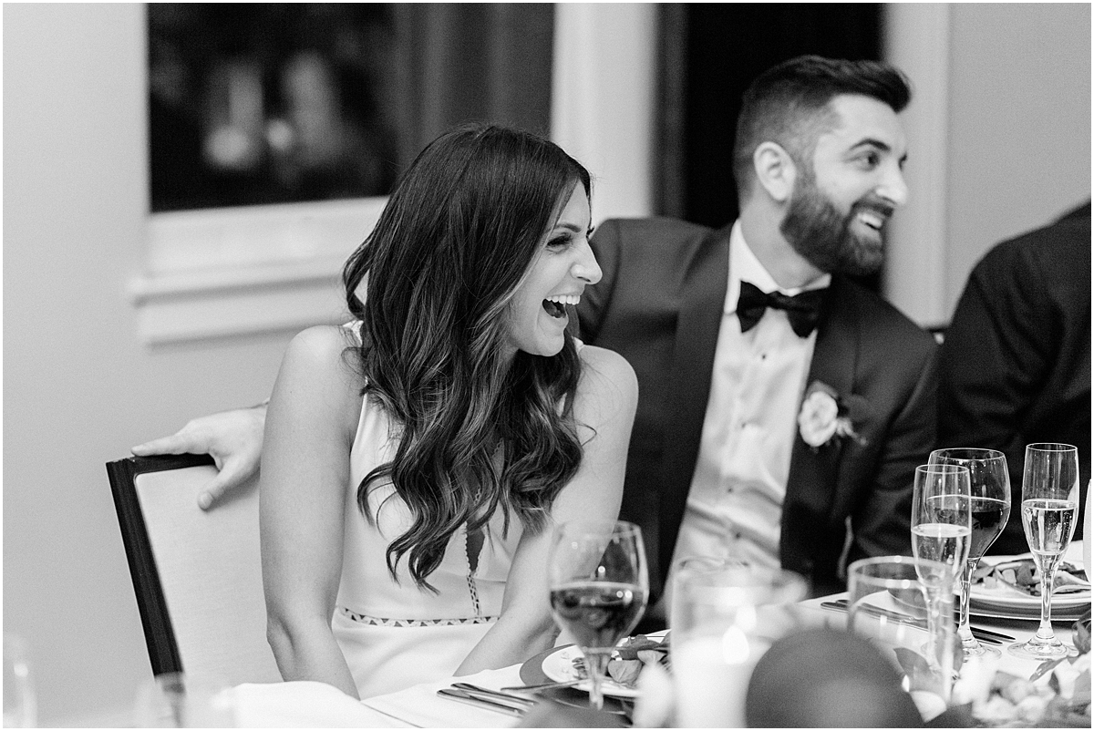 bride and groom laugh at wedding reception 