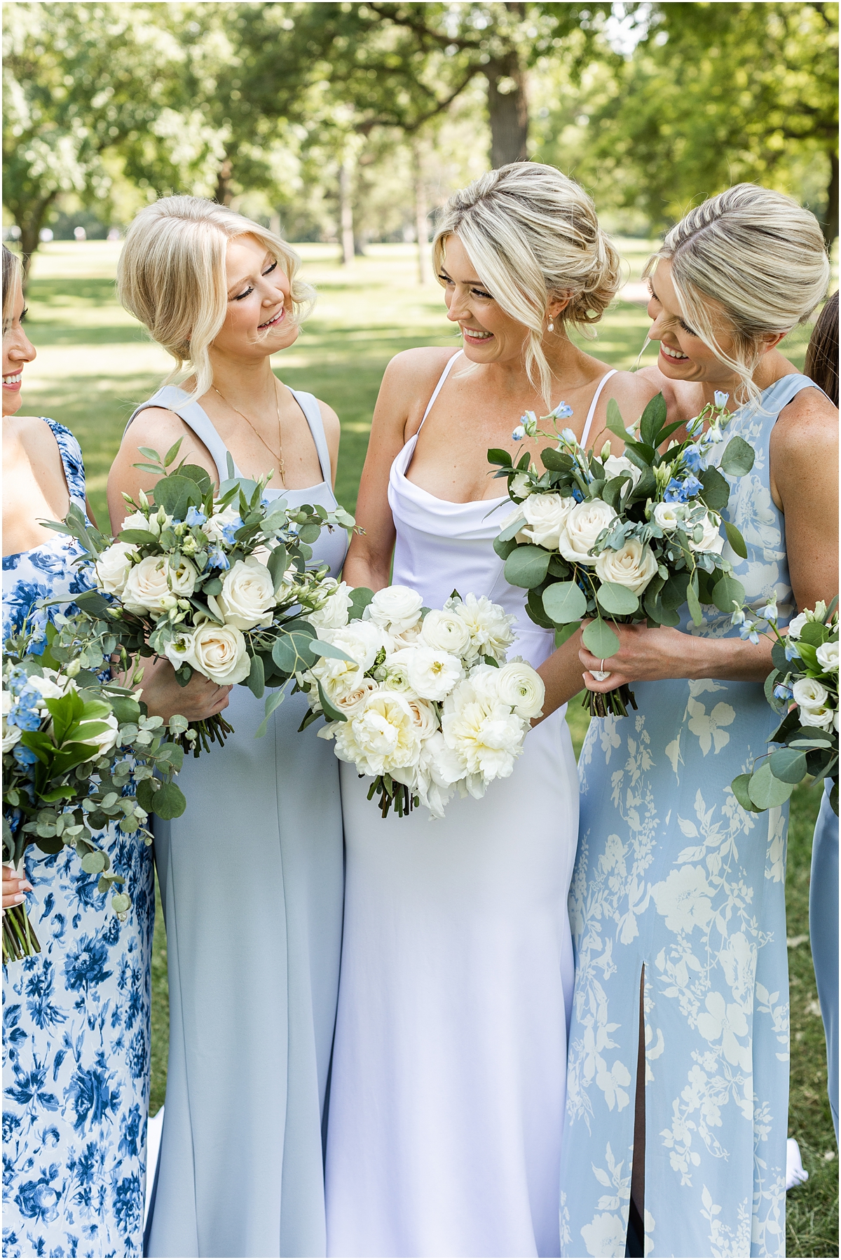 bride with bridesmaids in their individually chosen bridesmaids dresses