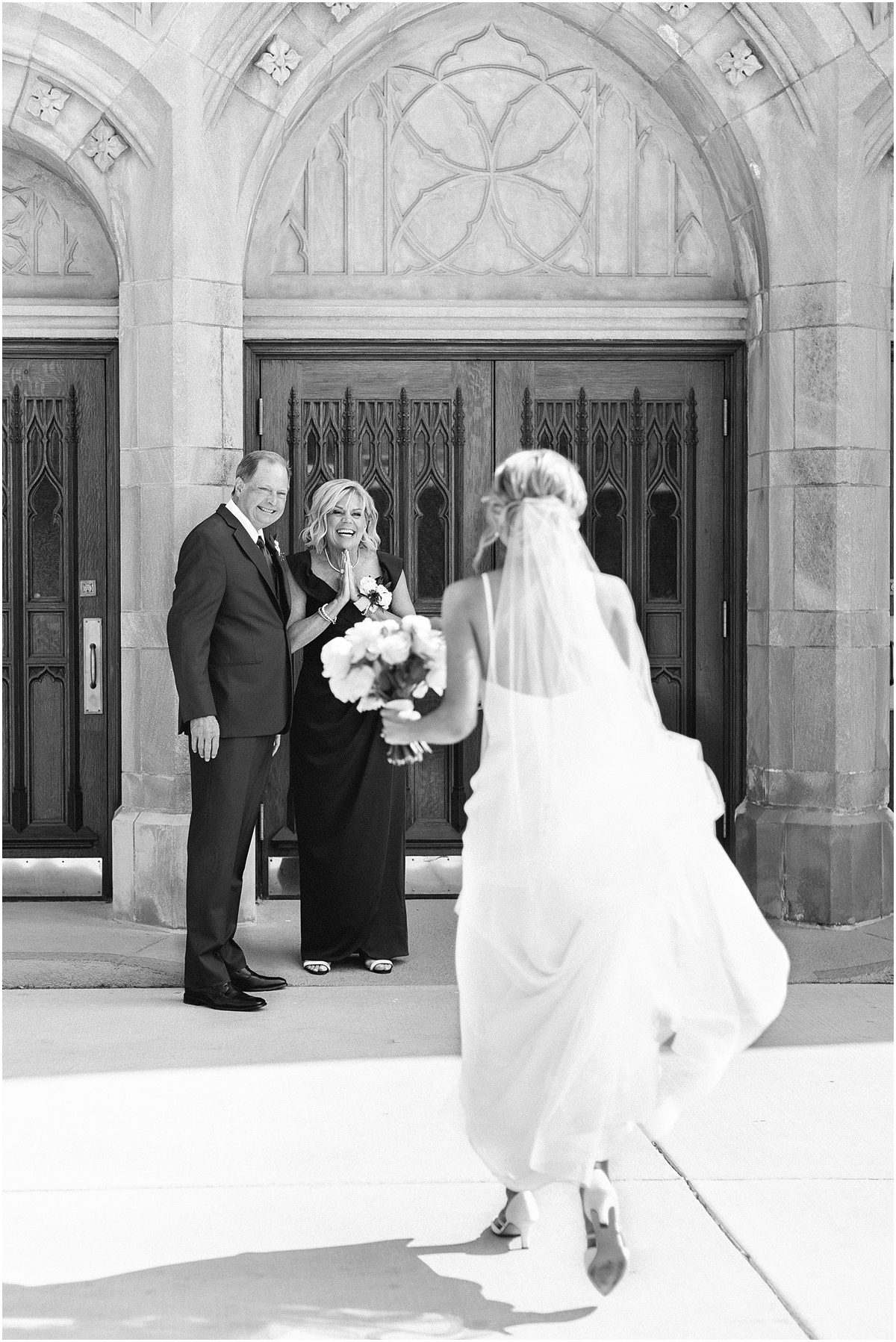 bride walking into immaculate conception church for wedding ceremony