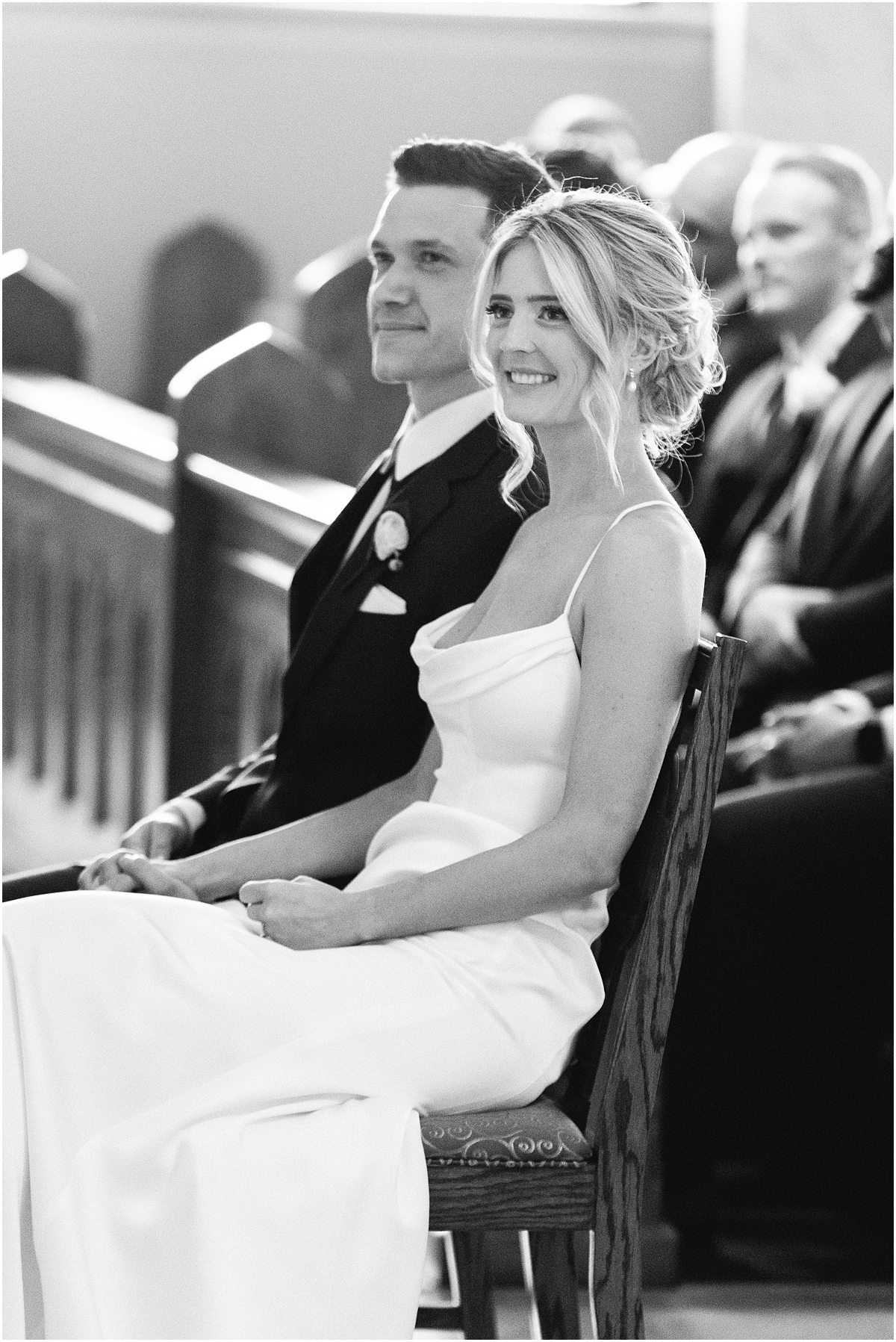 bride and groom sit during wedding ceremony