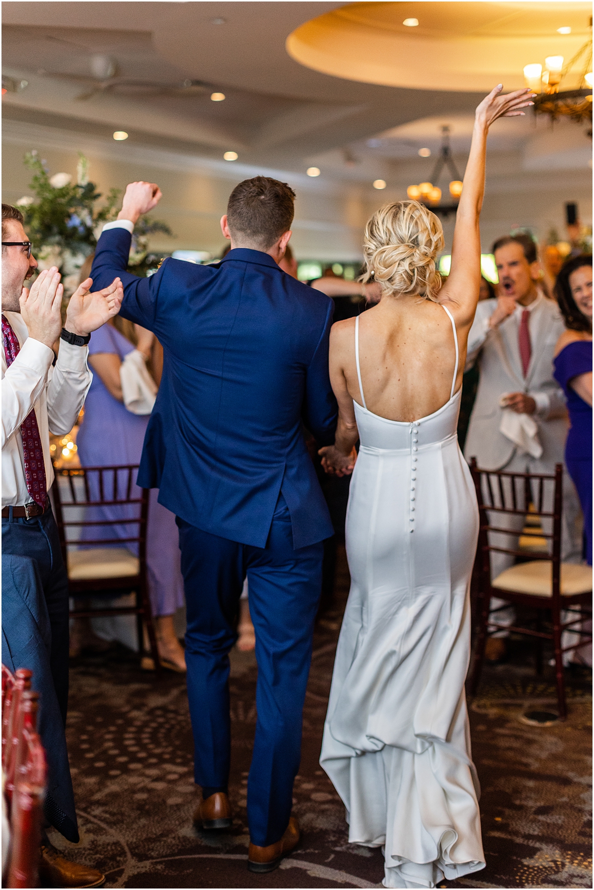 newlyweds make grand entrance into wedding reception