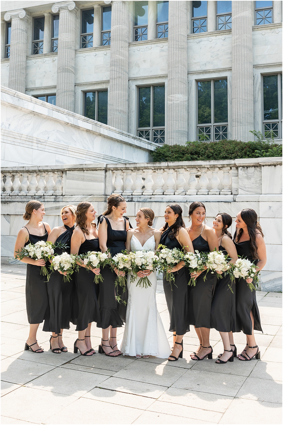 bride with bridesmaids in chic, black dresses