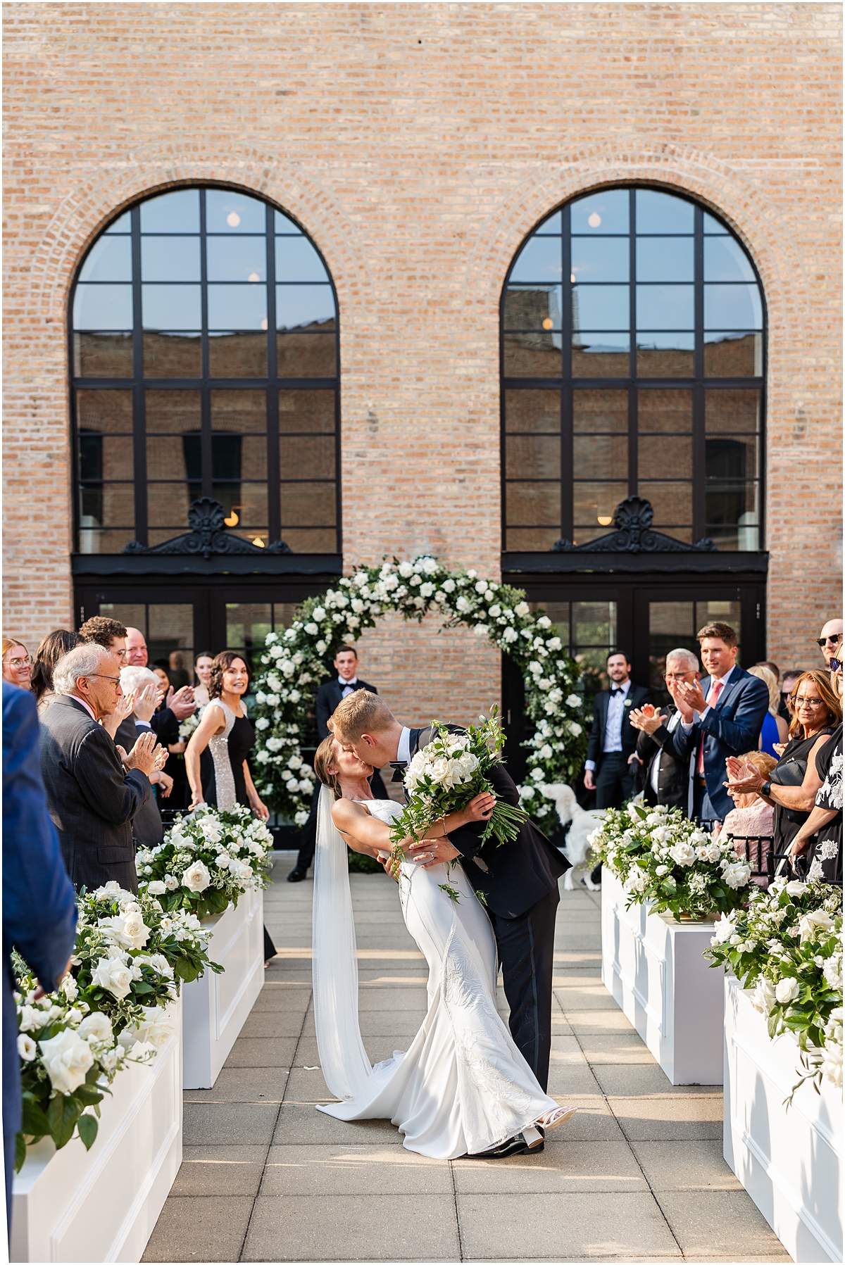 newlyweds kiss as they exit wedding ceremony
