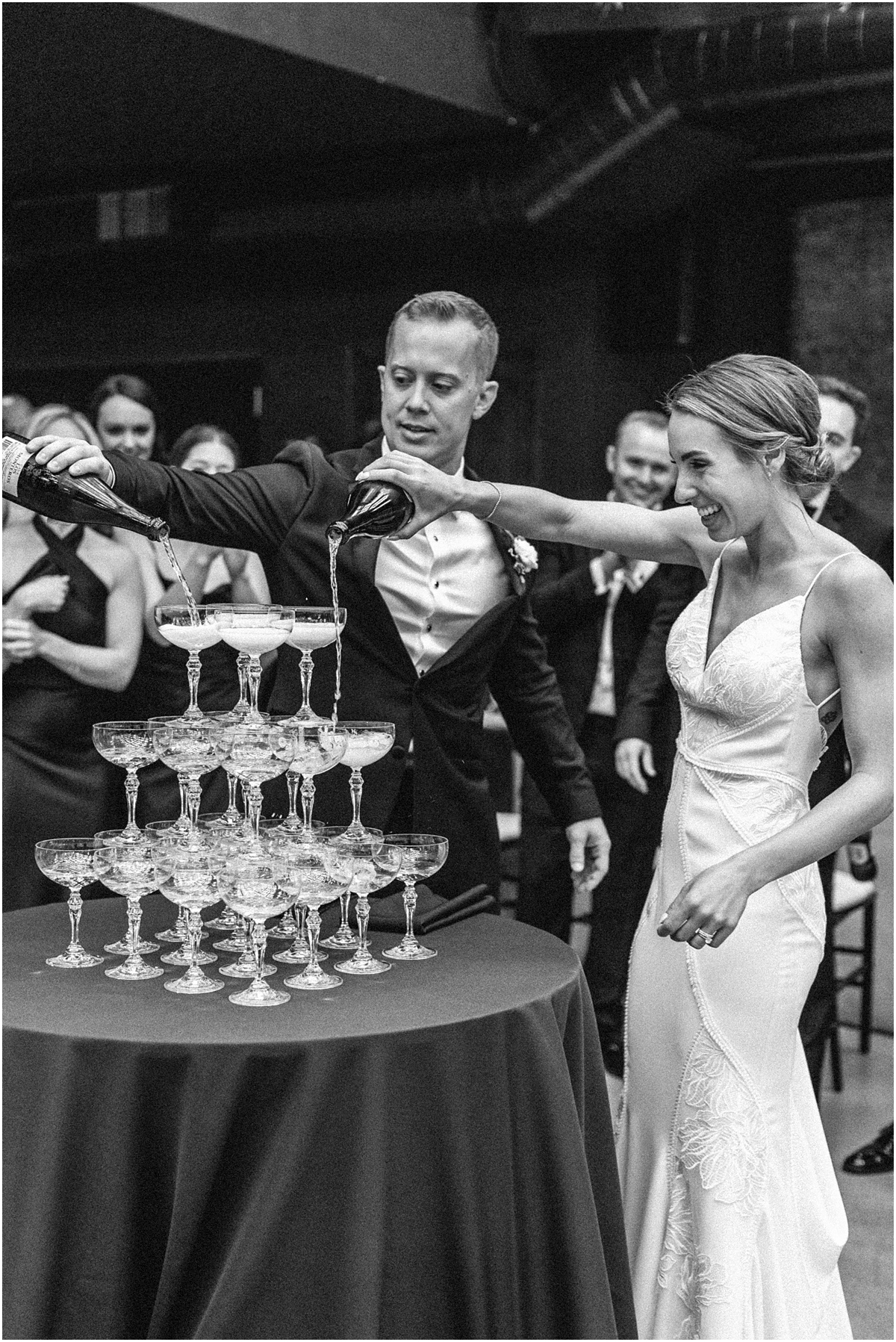 bride and groom pour champagne on tower