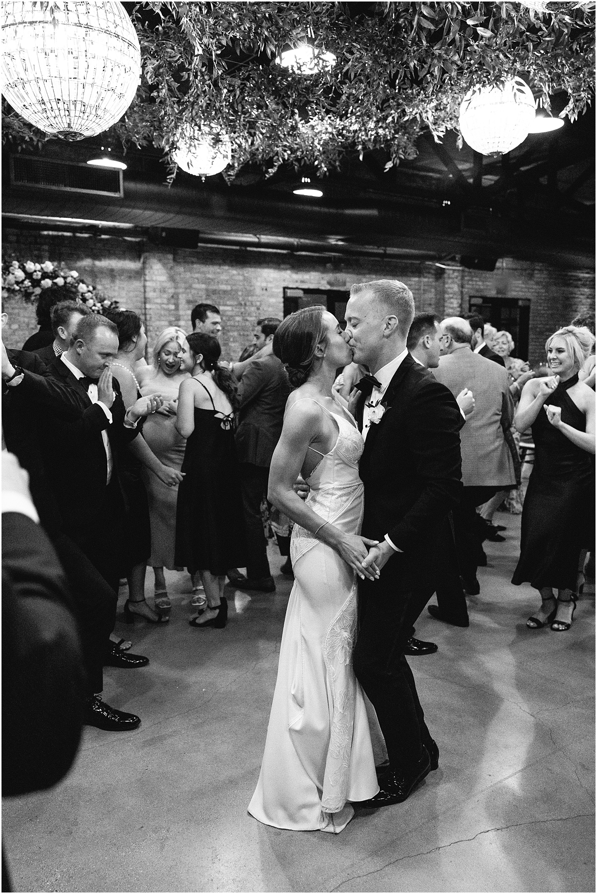 newlyweds kiss in the middle of the dance floor