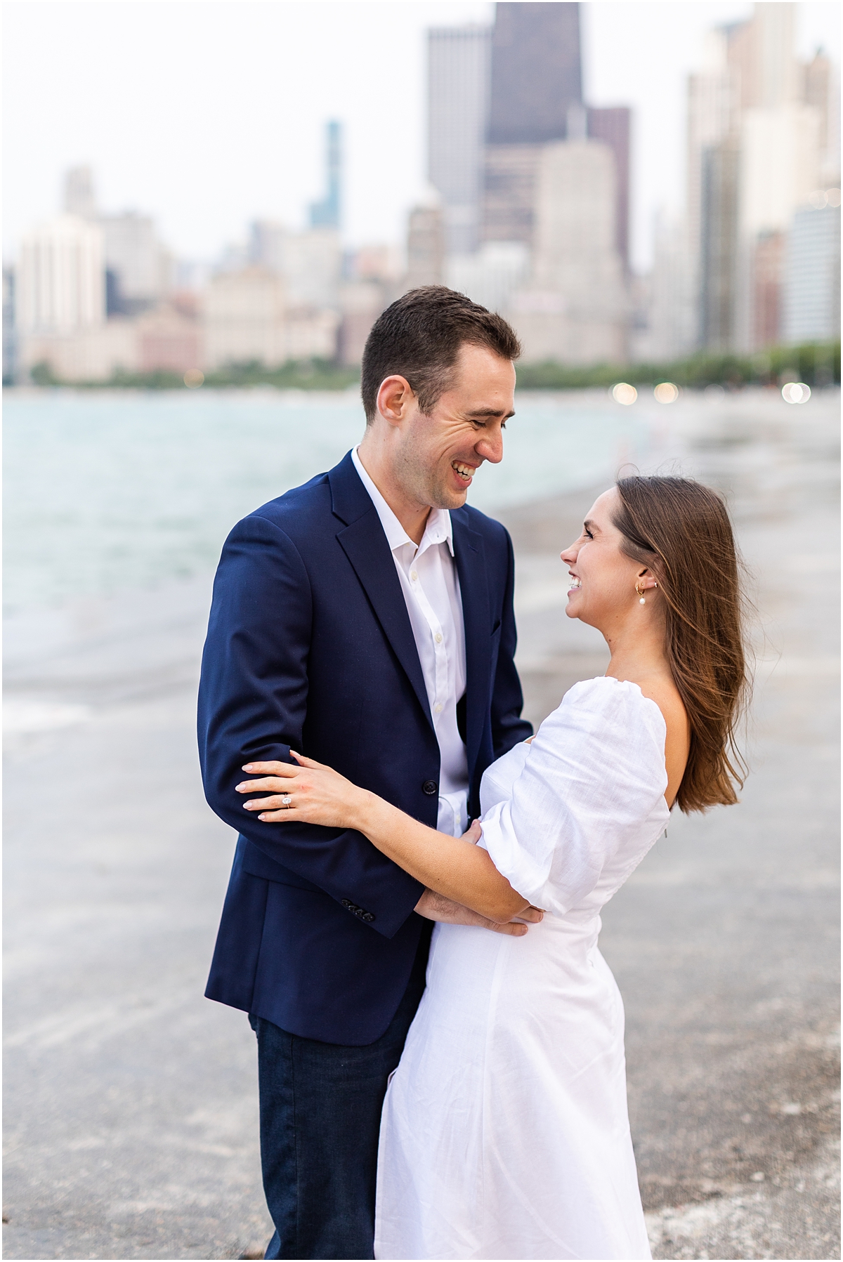 candid engagement portraits with the Chicago skyline in the background