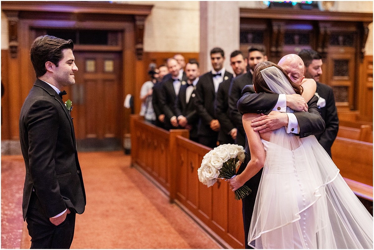 father hugs his daughter at Chicago wedding ceremony 