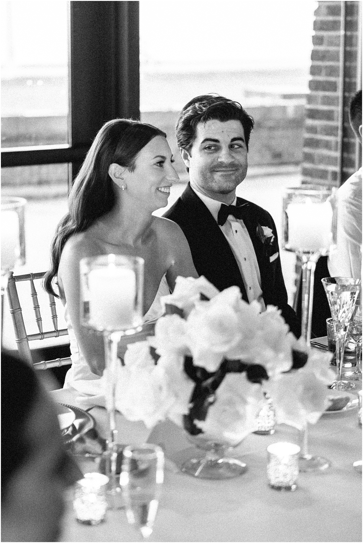 newlyweds at table during wedding speeches