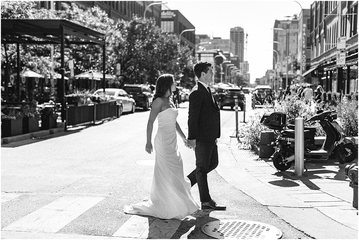 newlywed portraits of couple walking through Chicago's west loop