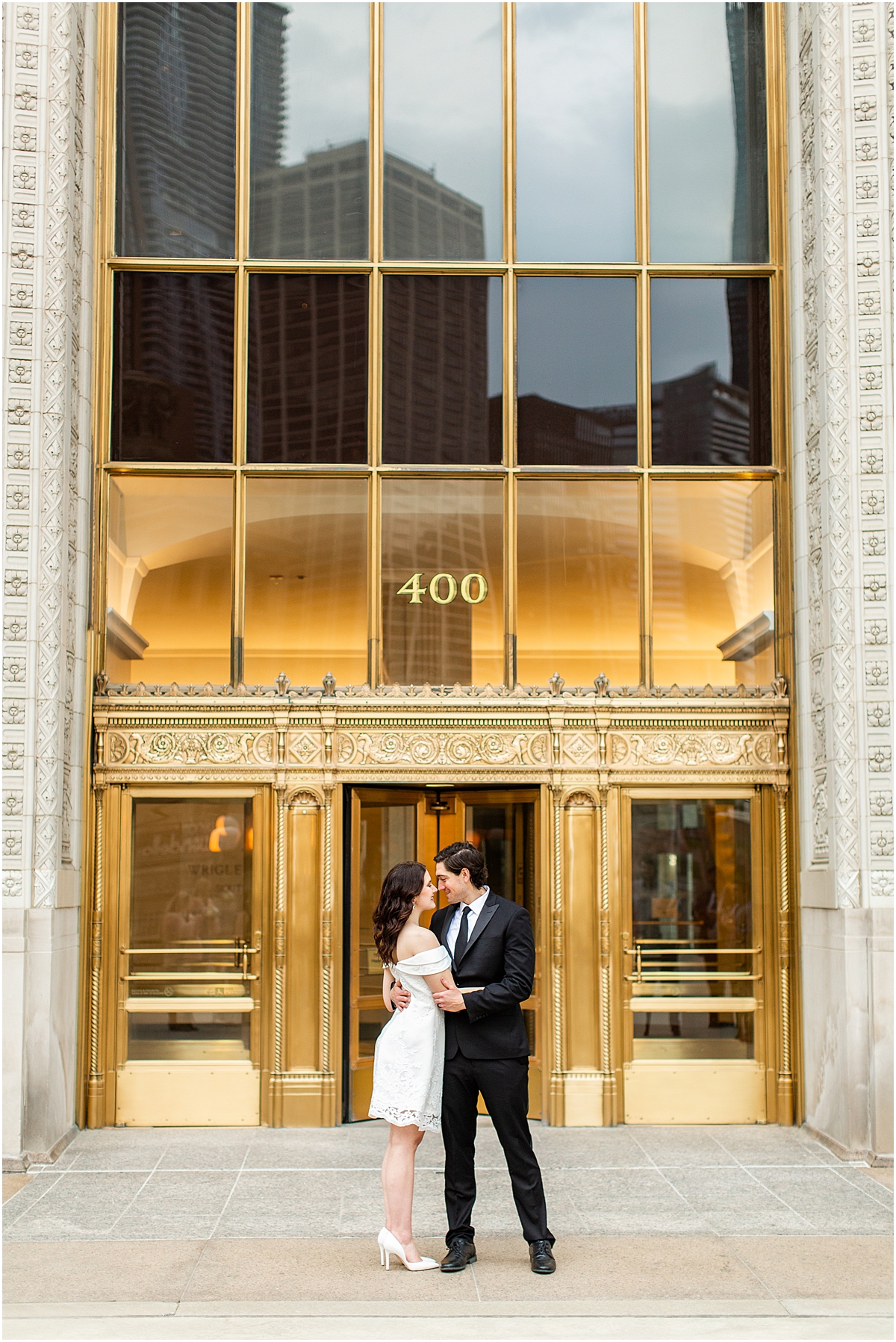 12 Best Chicago Engagement Session Locations | Couple outside of the Wrigley building