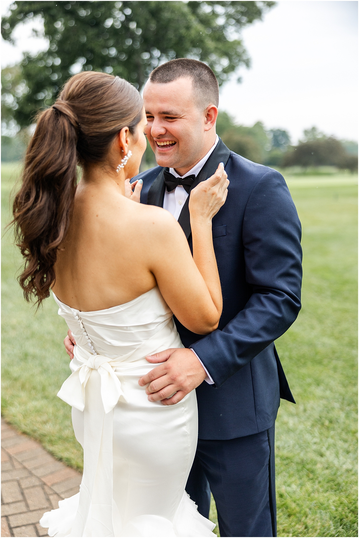 couple laugh together during wedding portraits