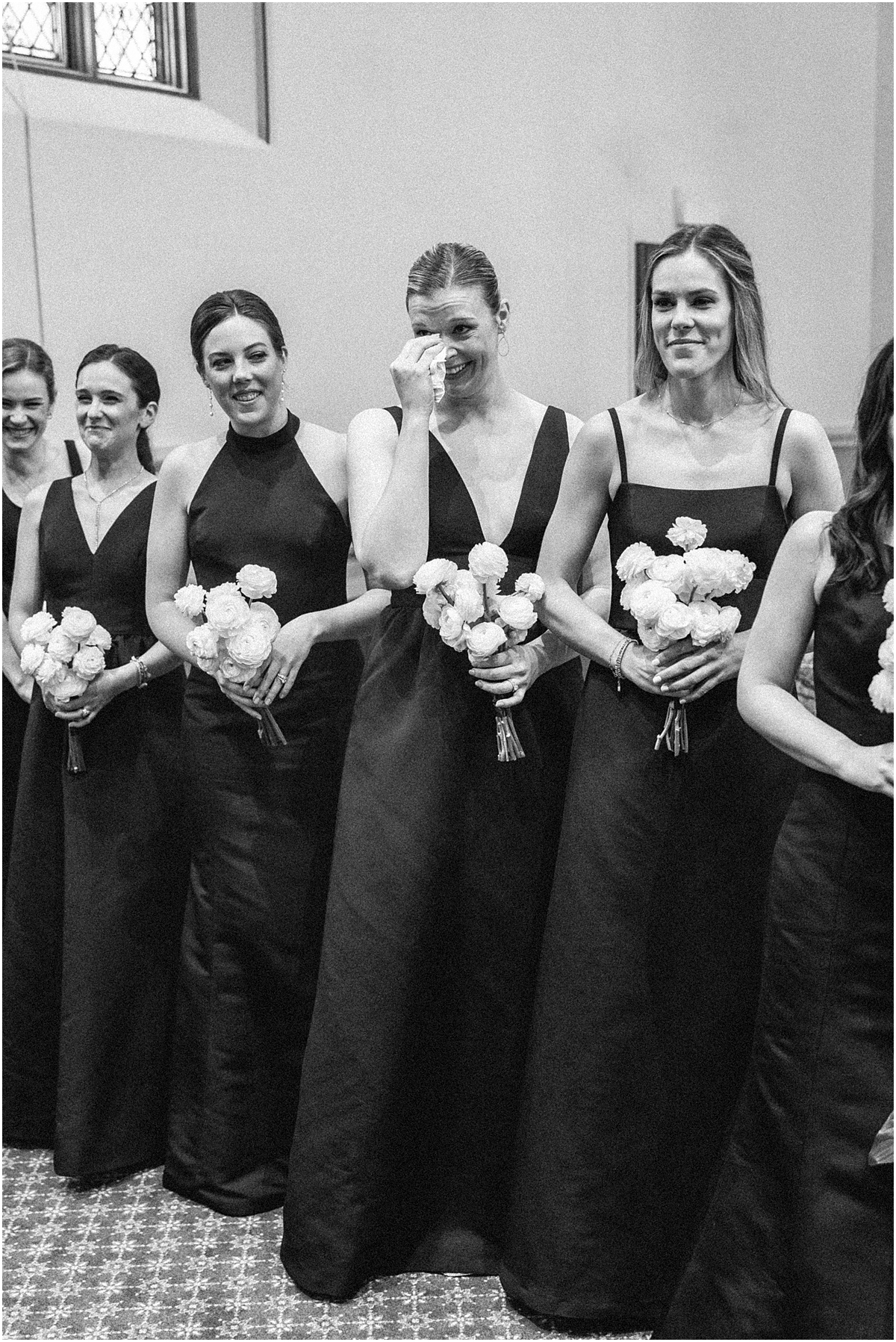 bridesmaids wipe away tears during ceremony