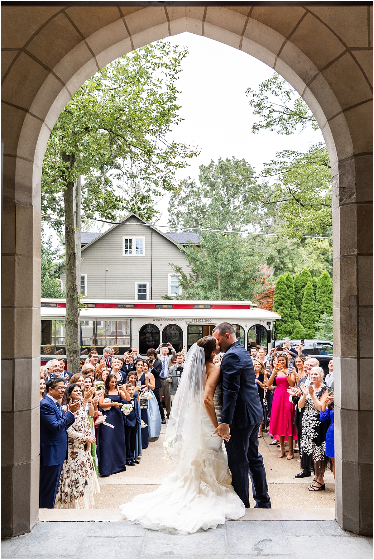 newlyweds kiss as they exit church ceremony