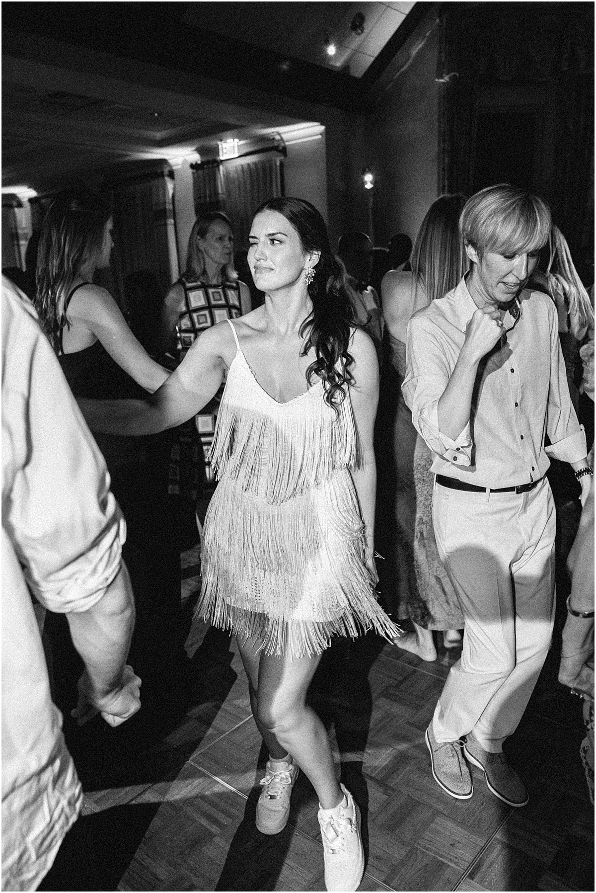 bride in fun fringe party dress at wedding reception