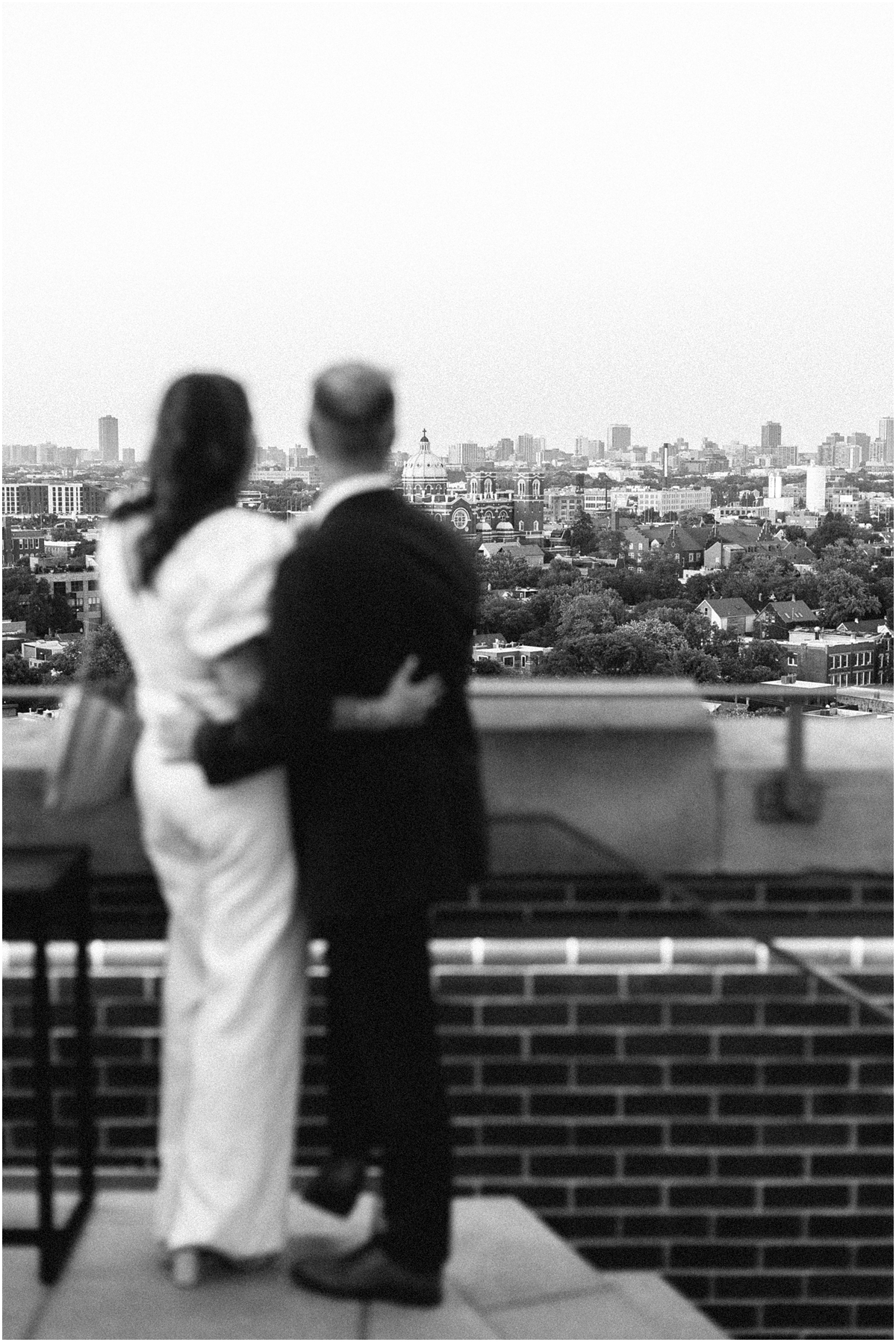 engaged couple take in view of Chicago from rooftop in Wicker Park