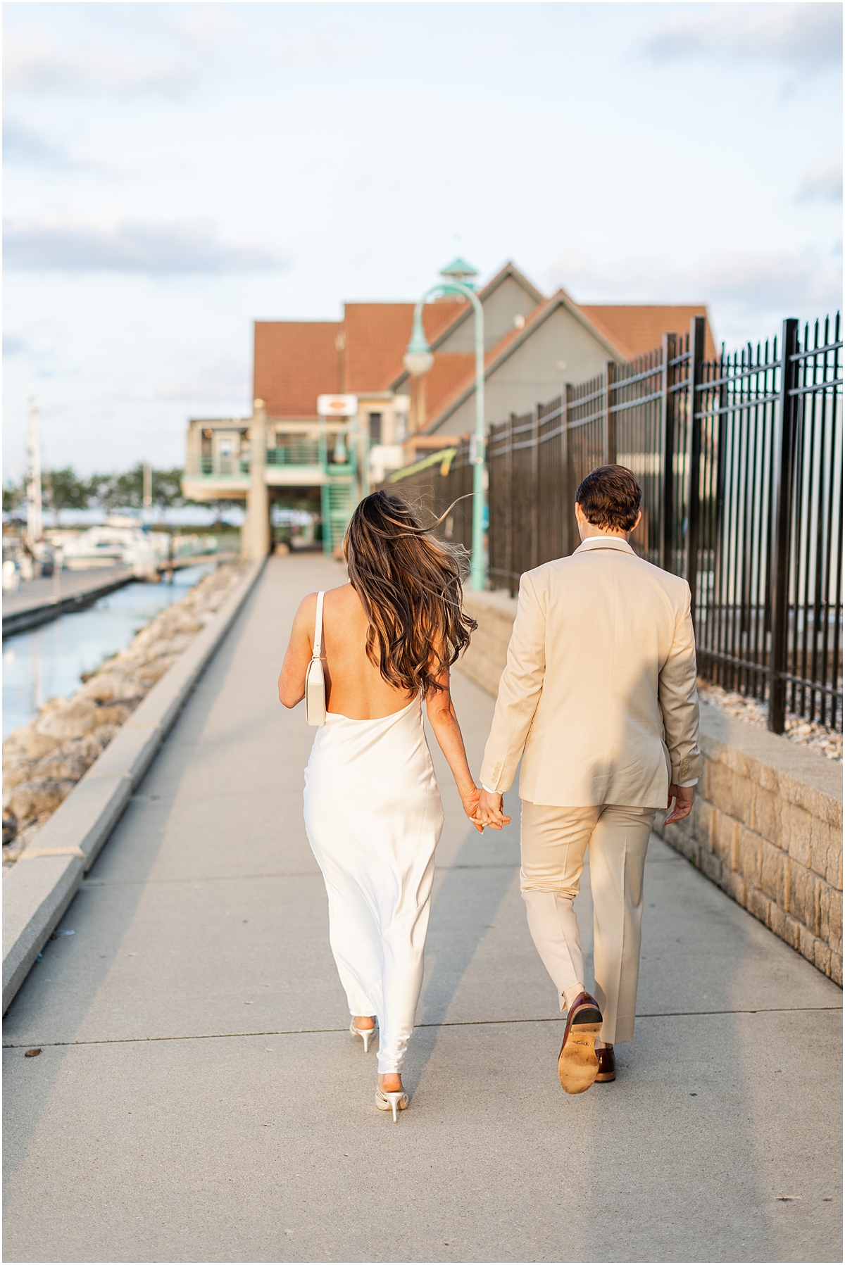 Bride and groom walk together holding hands
