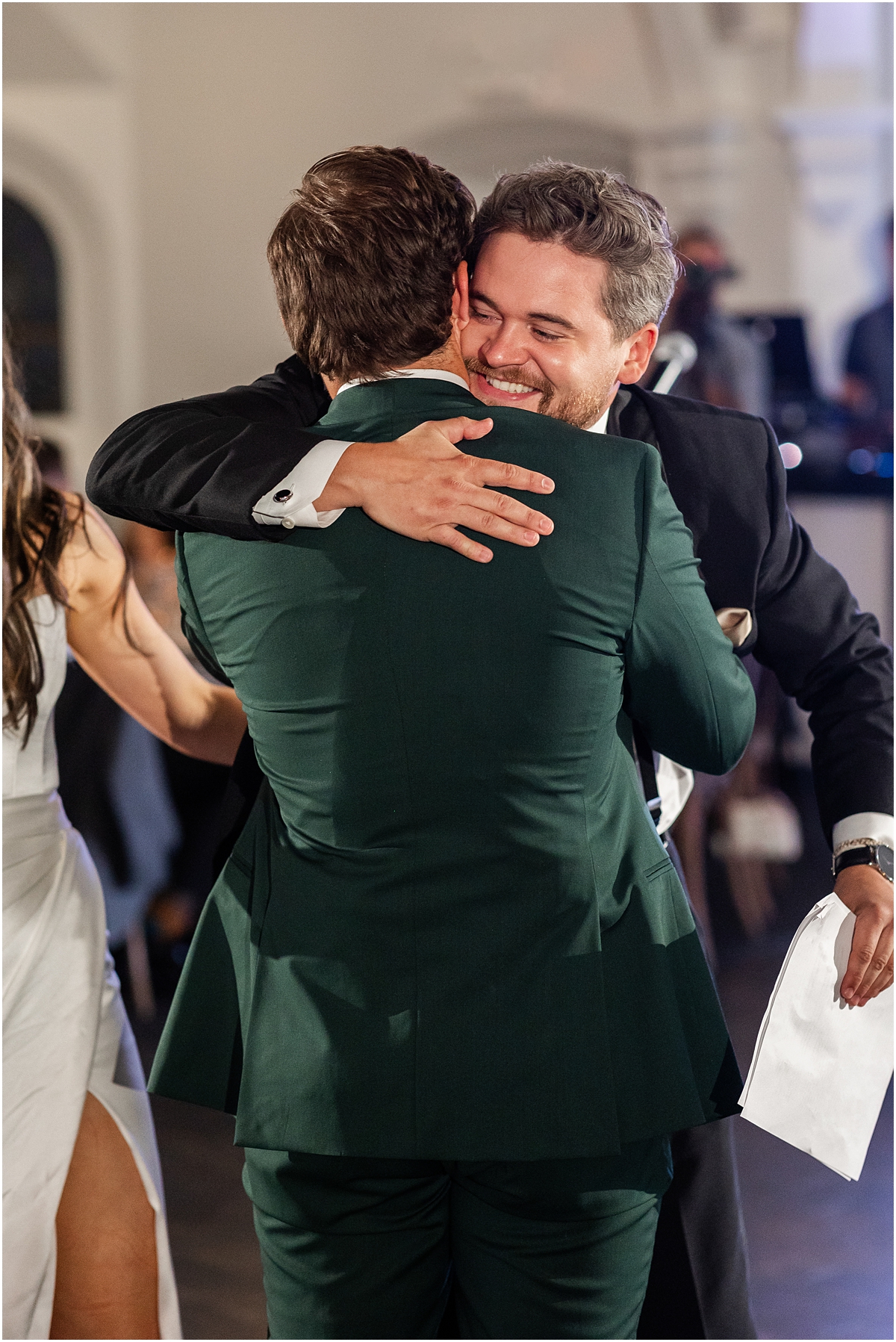 Best man hugs groom after speech