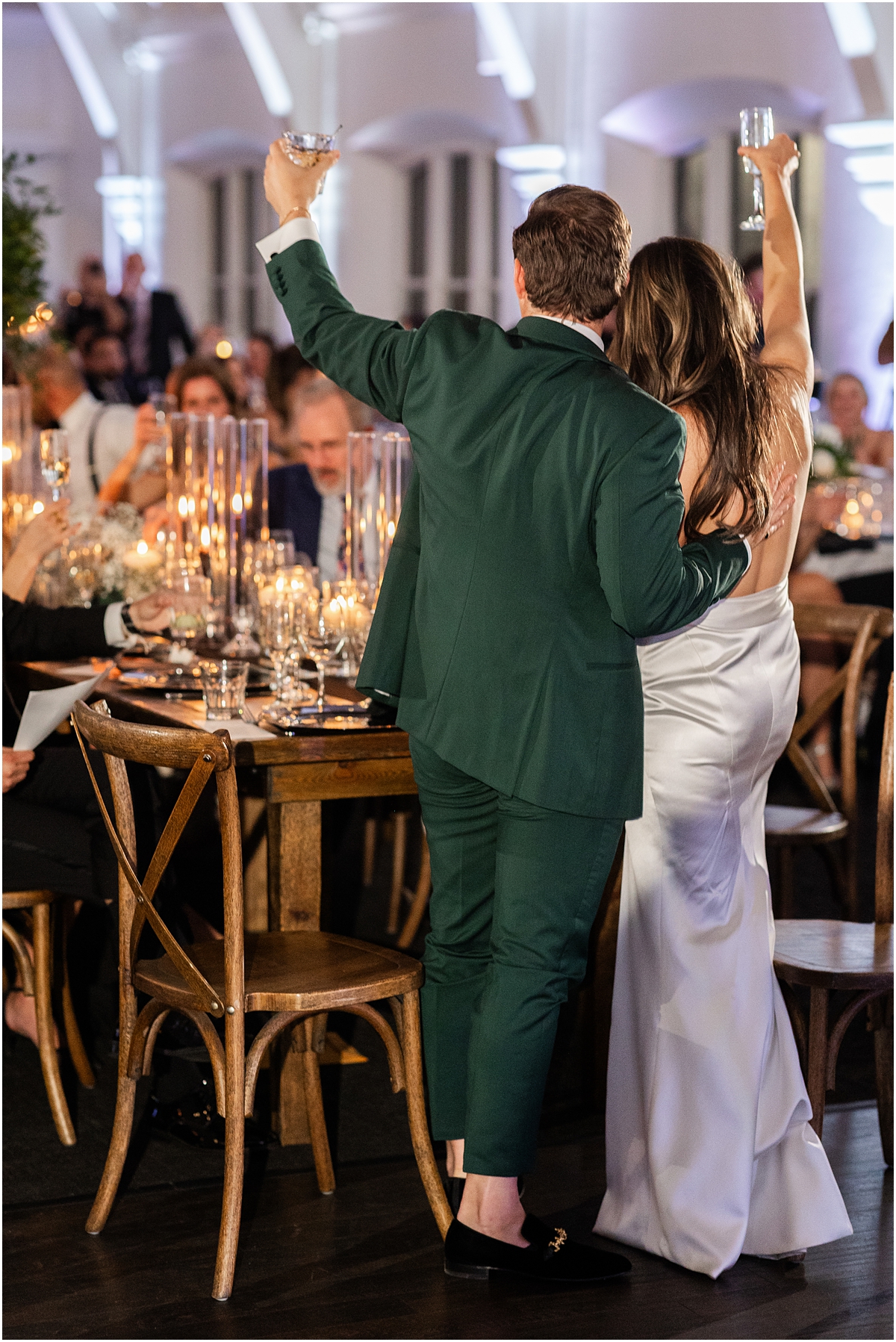 bride and groom raise their glasses in a toast