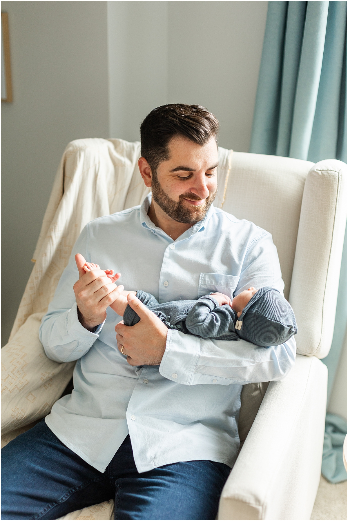 dad holds his son during In-Home Newborn Photography session