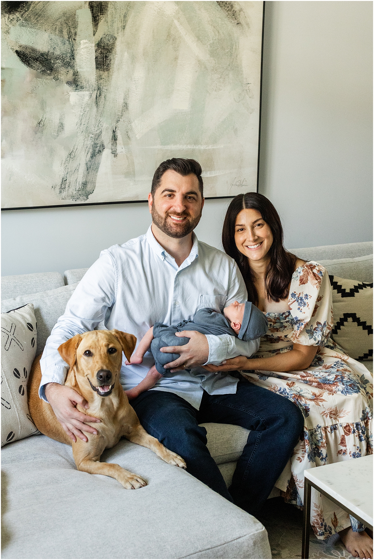 family portraits of parents holding newborn and their family dog