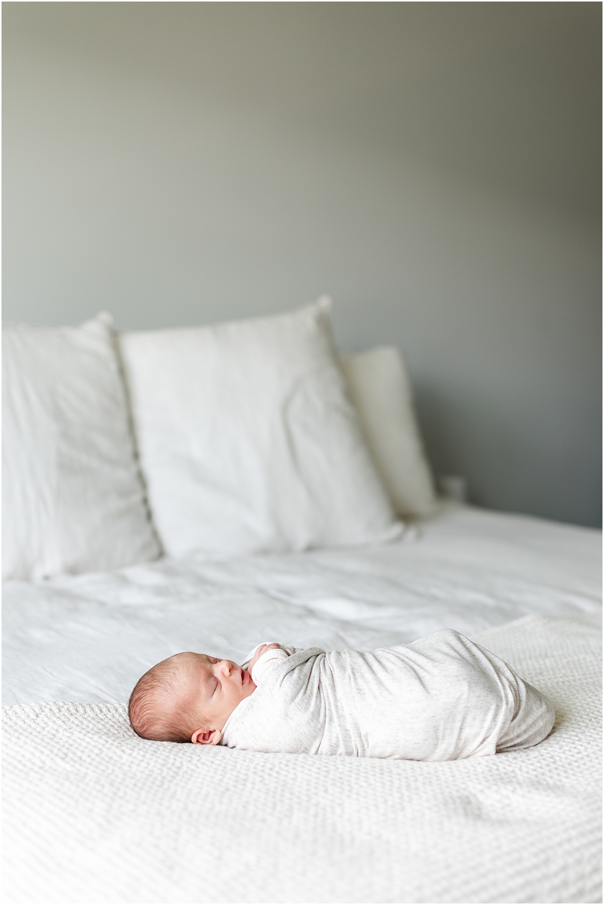 newborn boy wrapped in white blanket