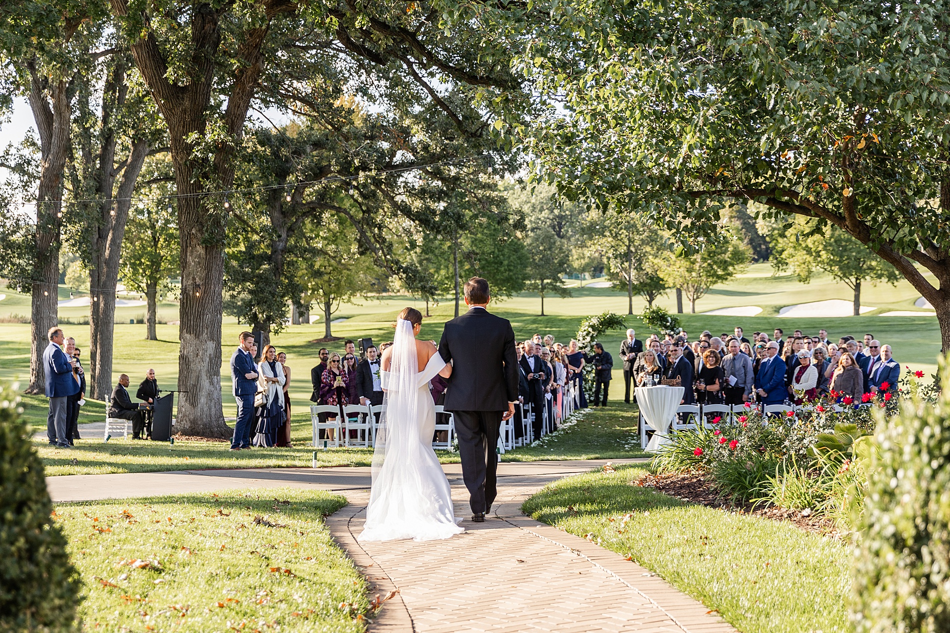 bride walks down the aisle with father 