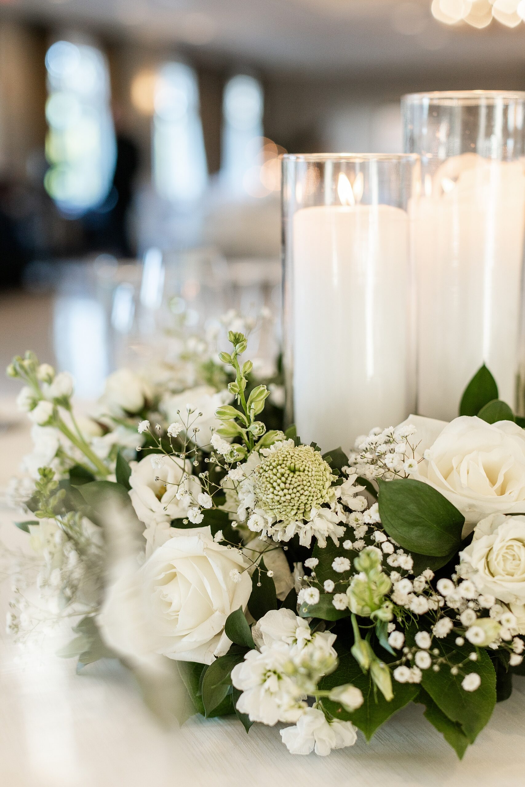 white wedding flowers and white candle centerpieces