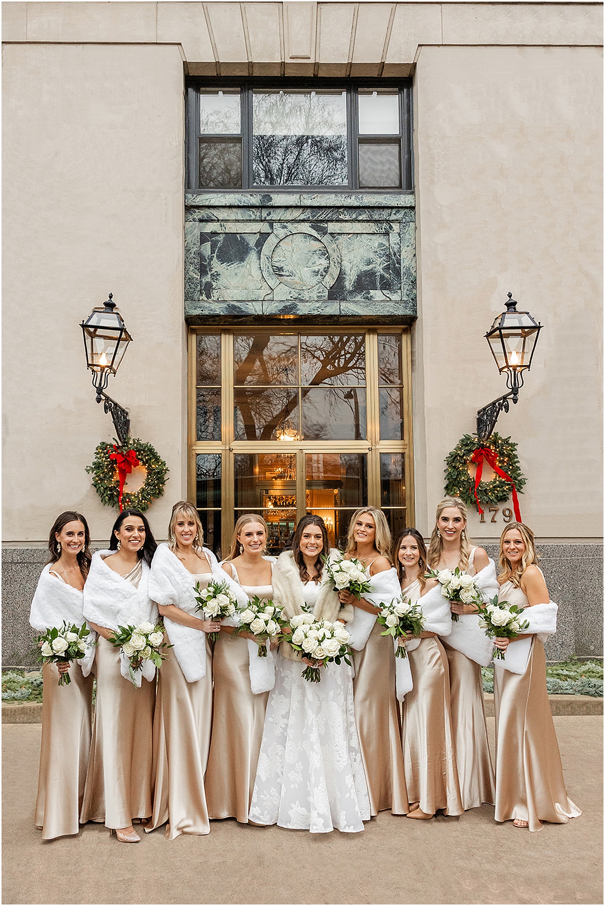bridesmaids in champagne dresses surround the bride