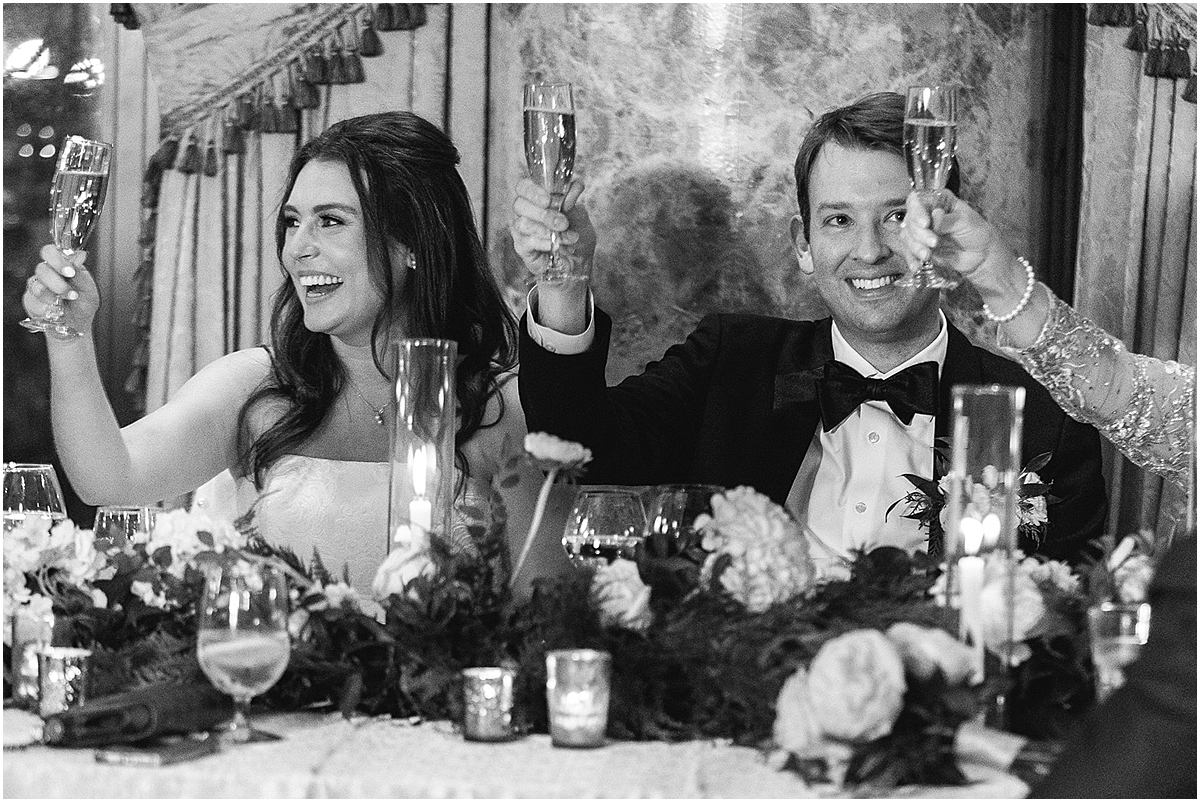 newlyweds toast at wedding reception
