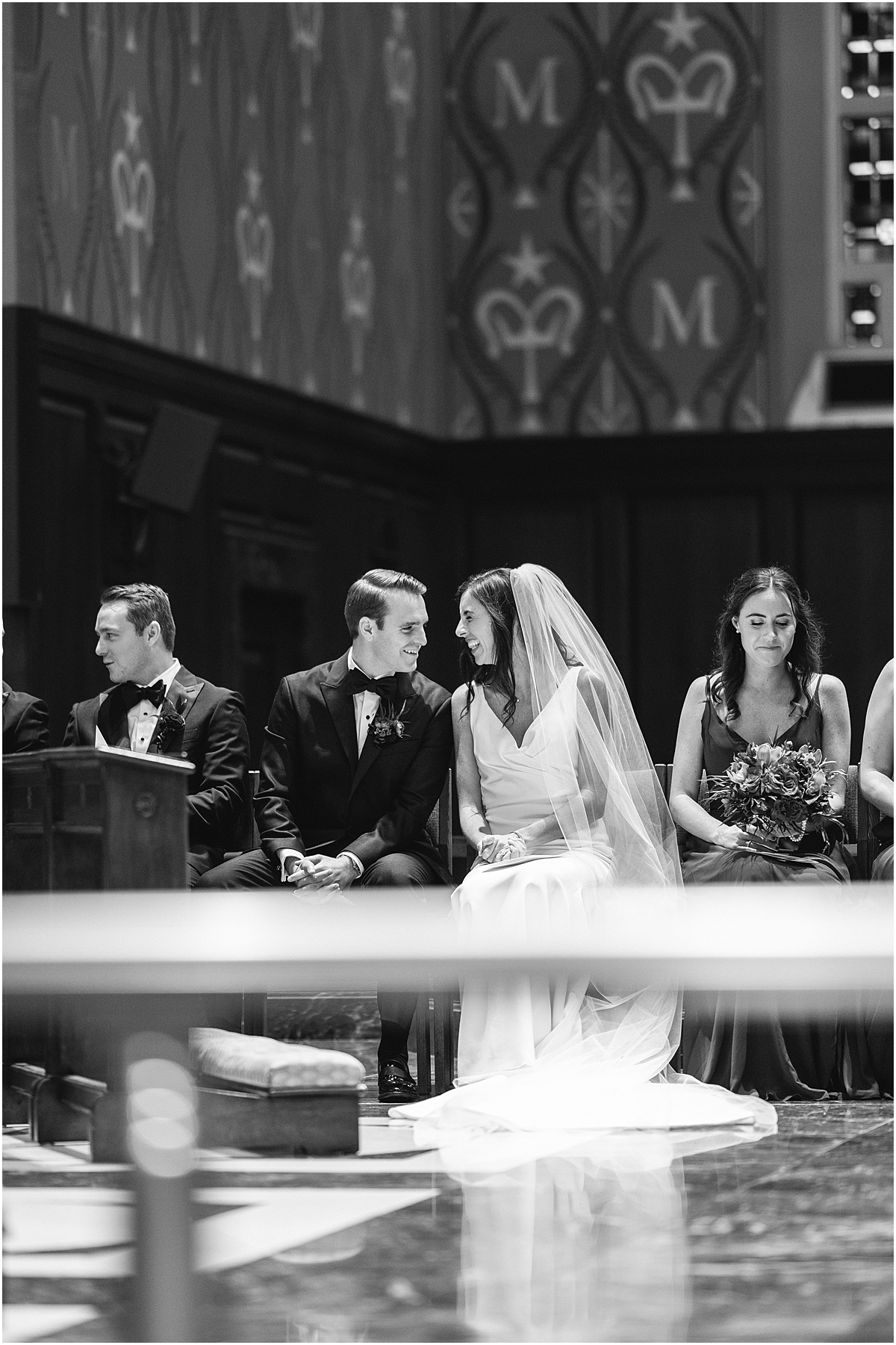 candid moment between bride and groom during ceremony 