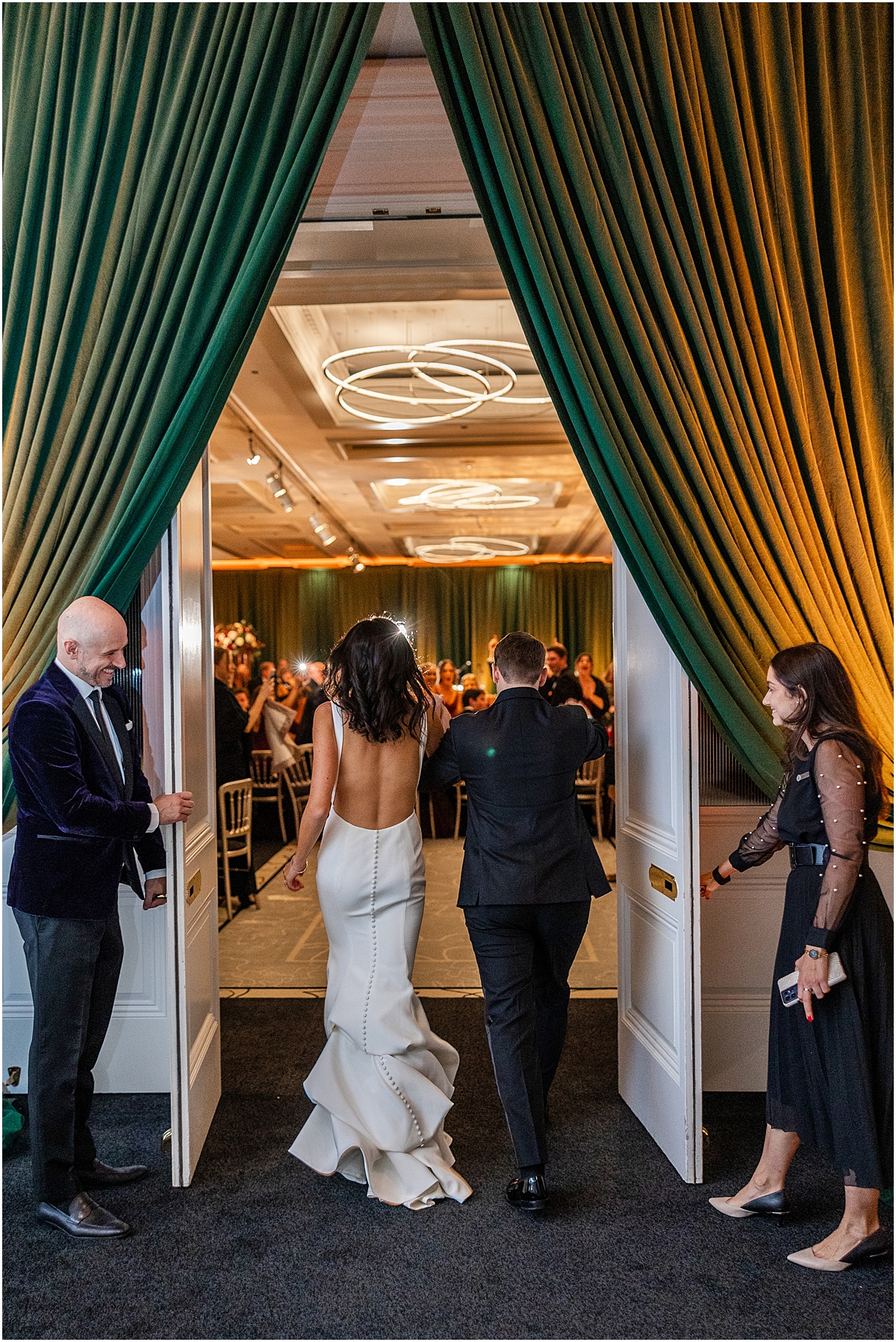 newlyweds enter their wedding reception at The Four Seasons Hotel  