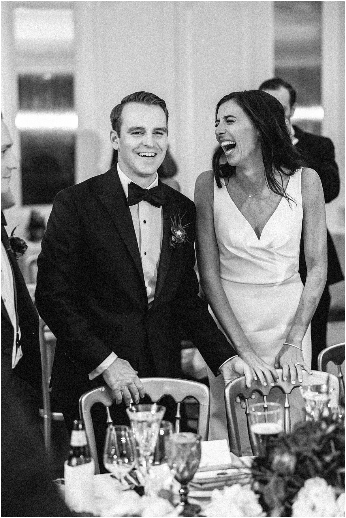 candid photo of couple laughing during wedding reception