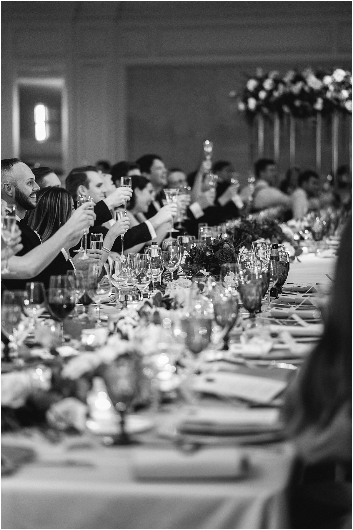 everyone raises their glasses to the newlyweds 
