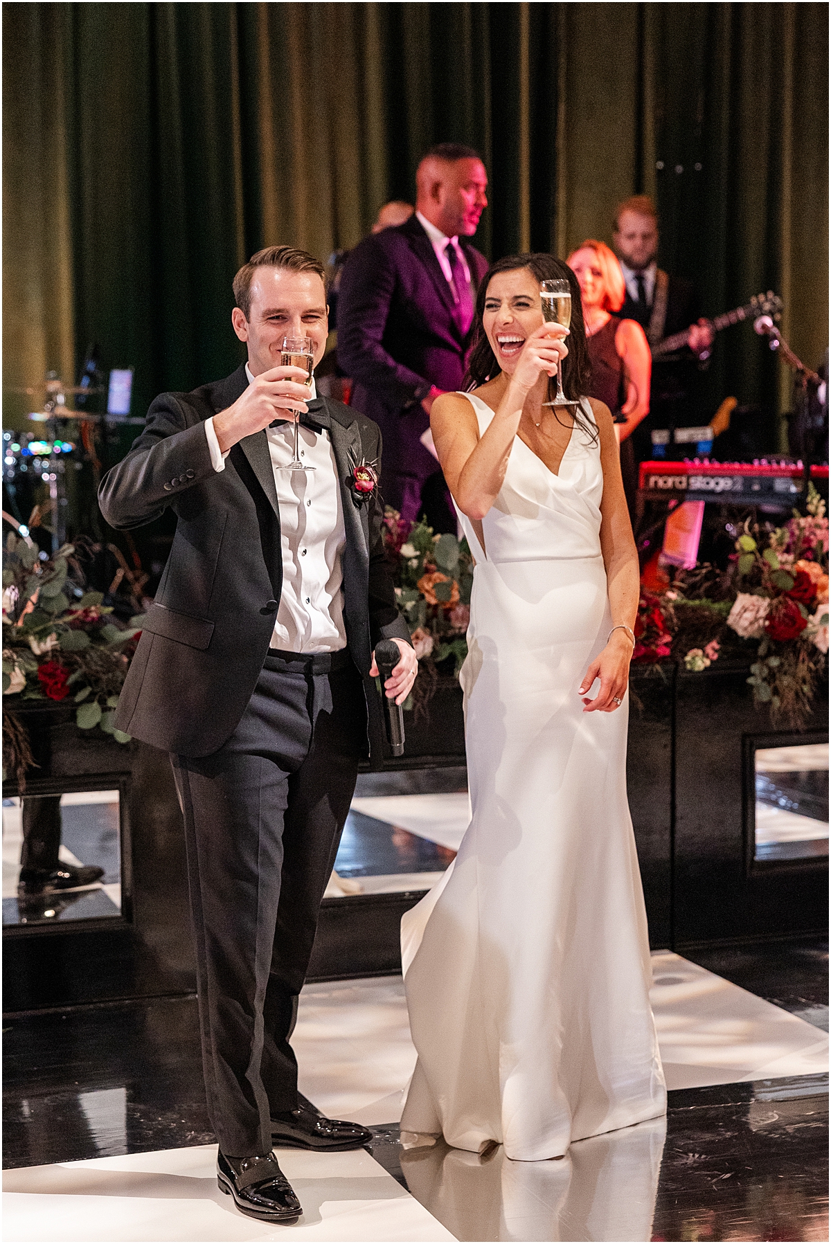 bride and groom raise their Champagne in a toast