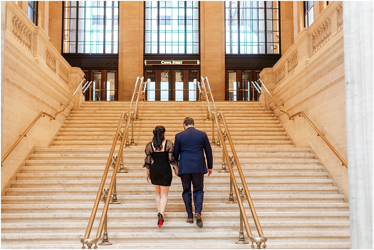 couple walk together up the stairs of the Chicago union station