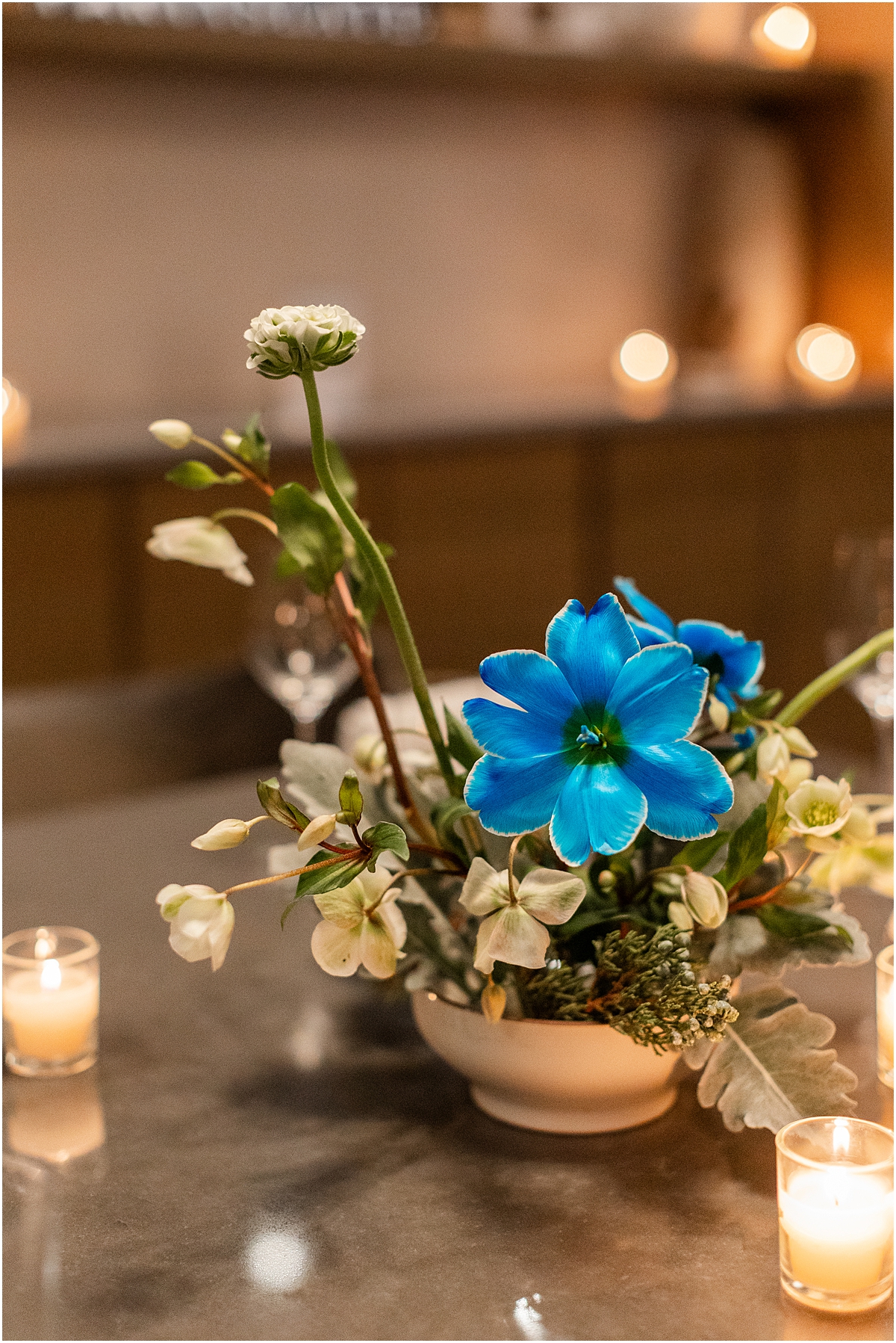 flower arrangements and candles decorate table