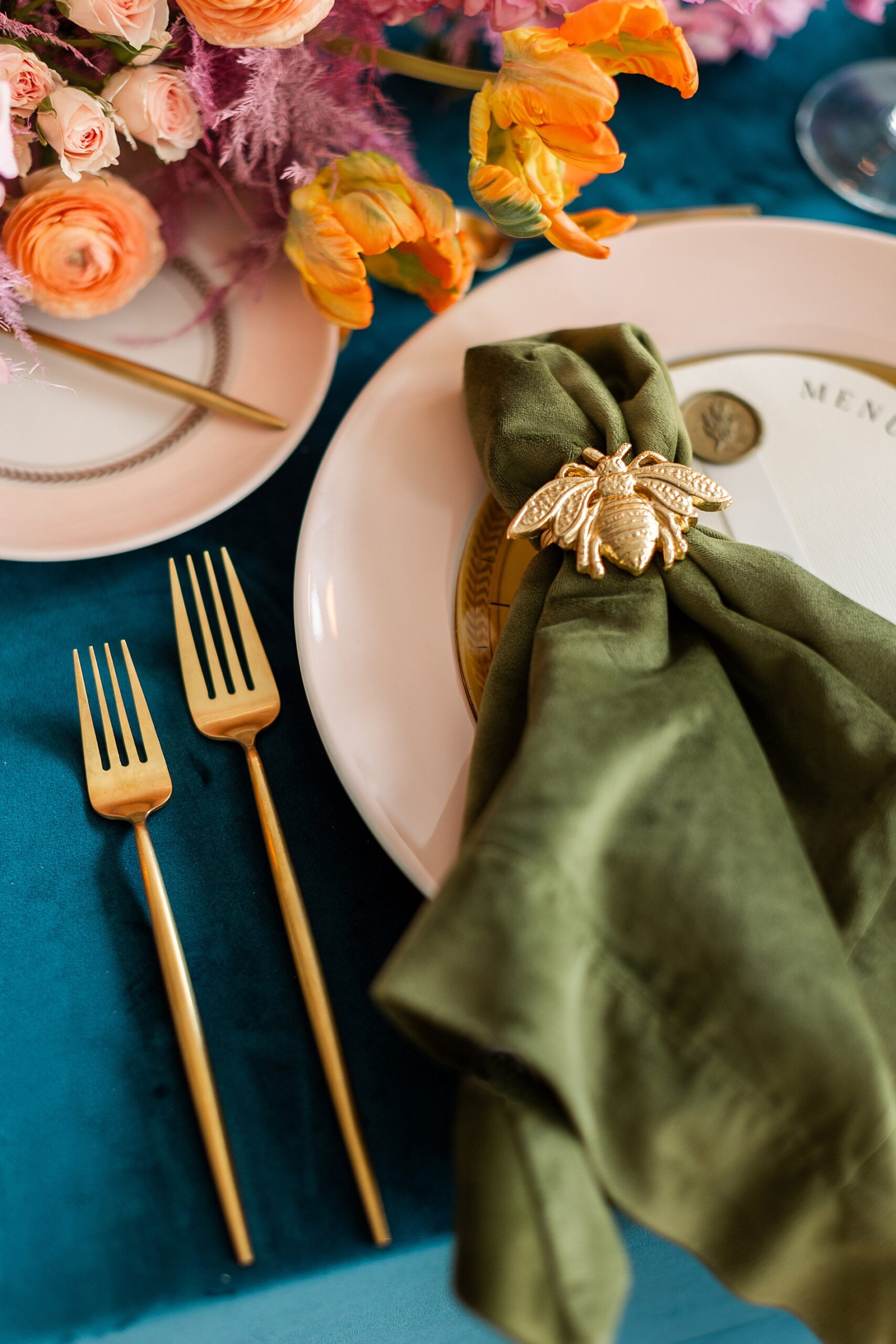 gold cutlery and green napkins with golden bee napkin ring