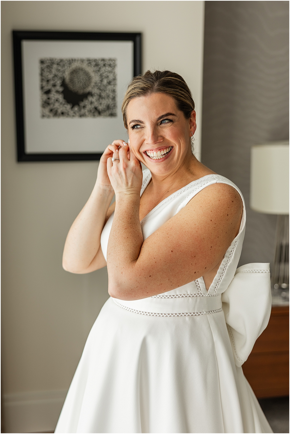 Bride getting ready putting earrings in