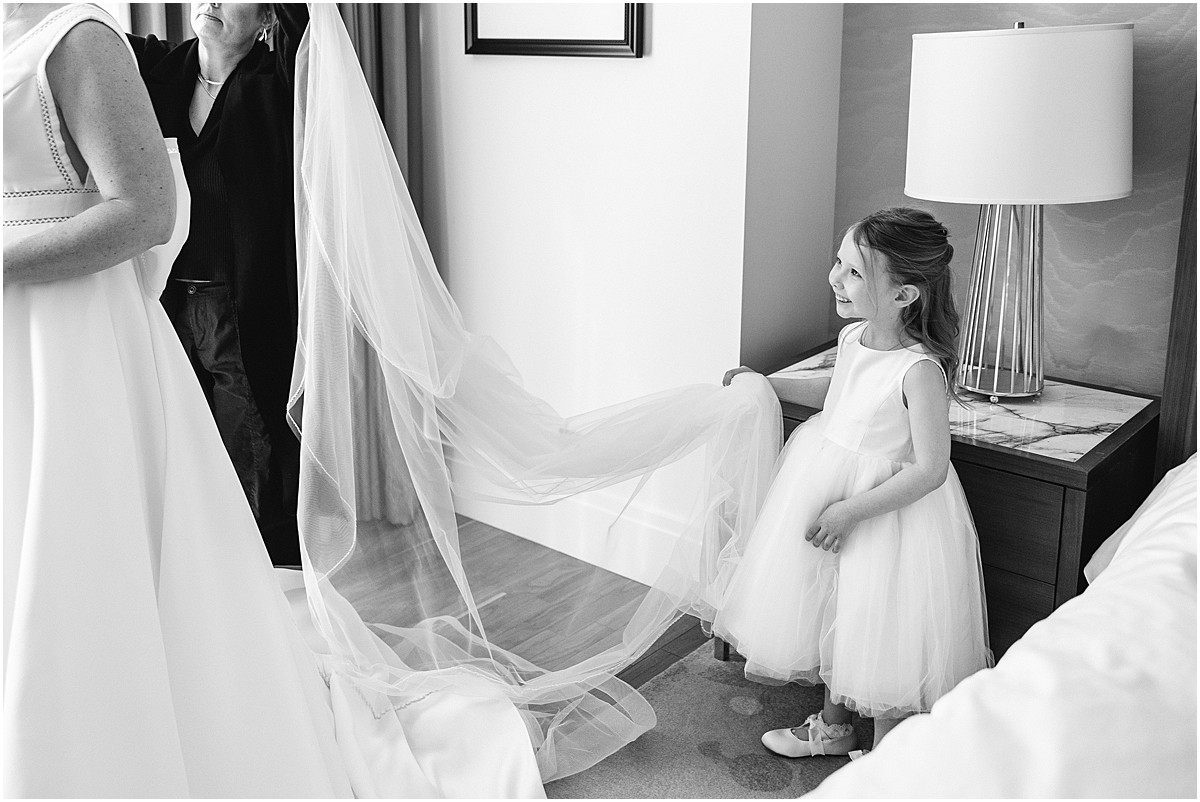 flower girl helps bride with veil