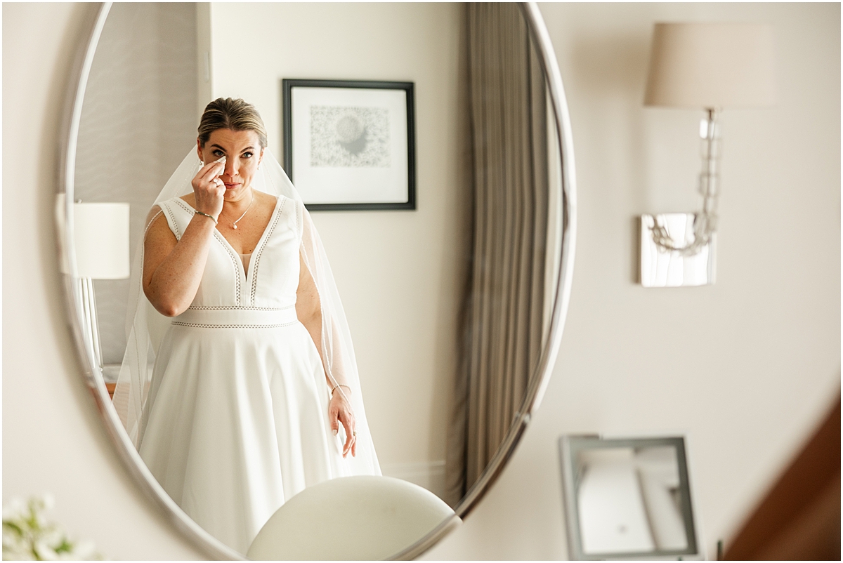 bride sees herself in the mirror at The Langham