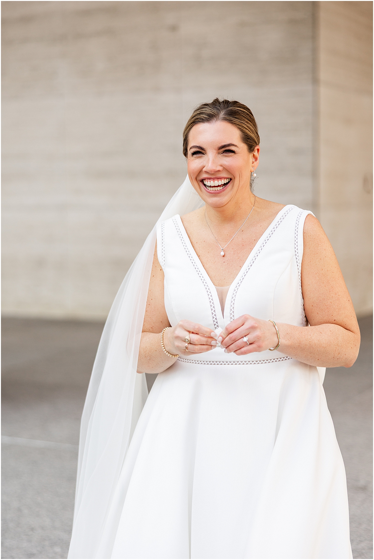 bride smiles during first look with groom
