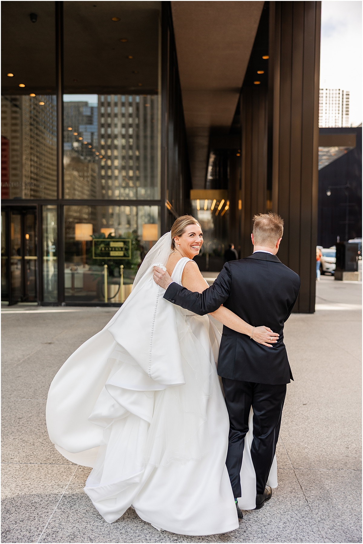 bride and groom walk together in downtown Chicago