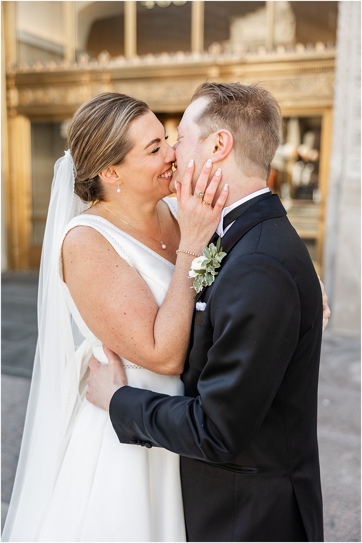 bride and groom kiss outside of building in downtown Chicago