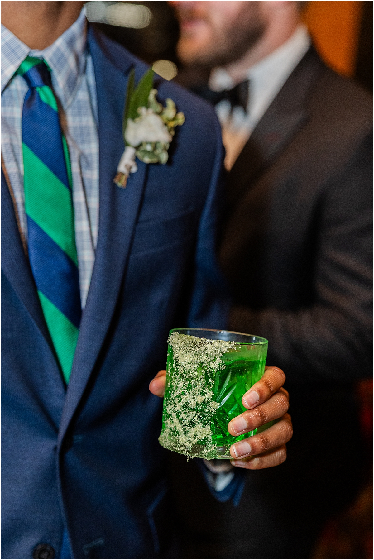 guy holds green cocktail from Spring Wedding at Chicago Winery on St. Patrick's Day
