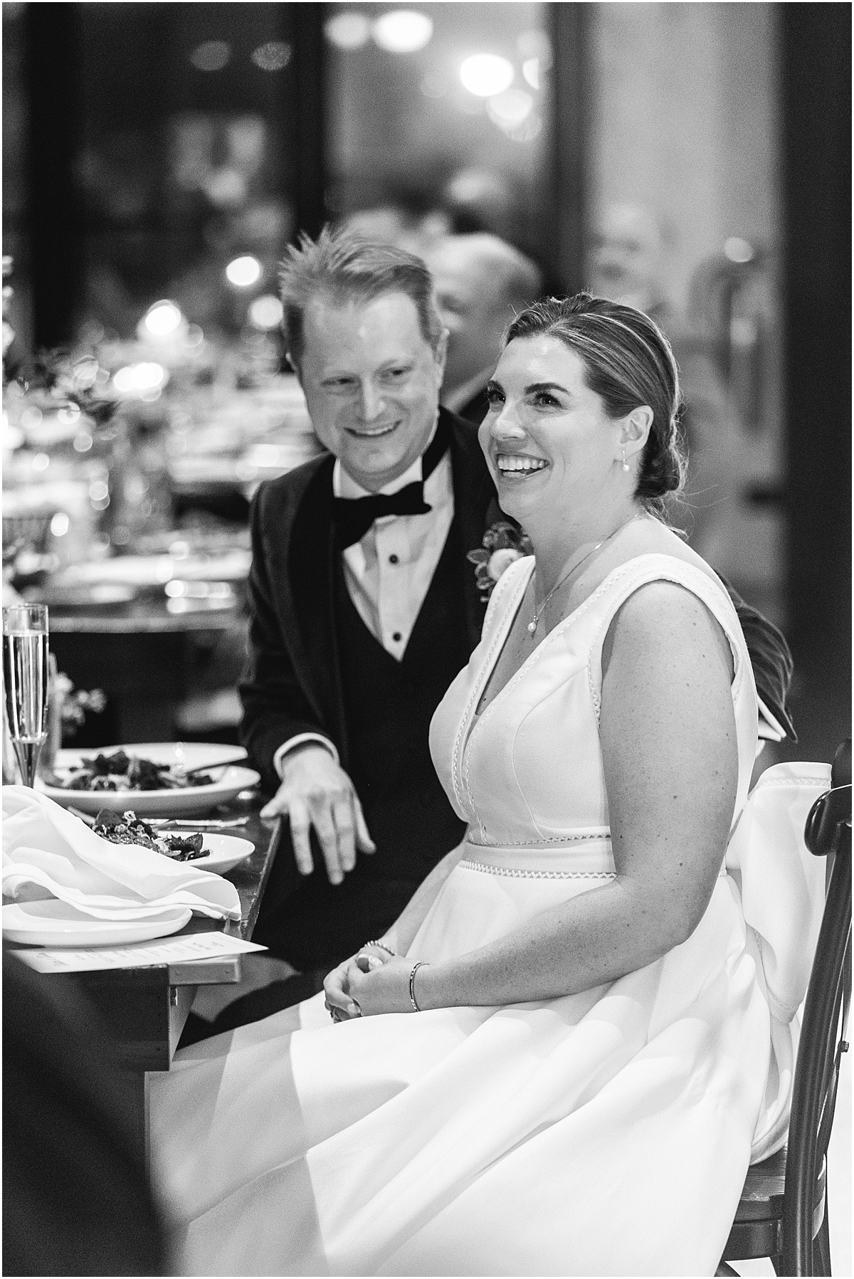 candid photo of bride and groom during wedding speeches