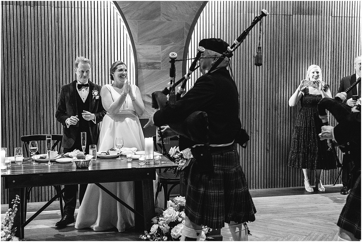 man plays bag pipes at wedding reception